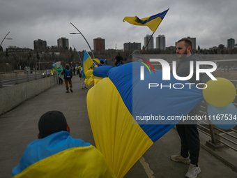 EDMONTON, CANADA - APRIL 21, 2024:
Members of the Ukrainian diaspora proudly wave national flags, hold blue and yellow balloons, and display...