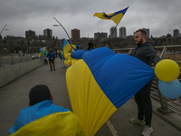 EDMONTON, CANADA - APRIL 21, 2024:
Members of the Ukrainian diaspora proudly wave national flags, hold blue and yellow balloons, and display...