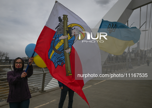 EDMONTON, CANADA - APRIL 21, 2024:
Members of the Ukrainian diaspora proudly wave national flags, hold blue and yellow balloons, and display...