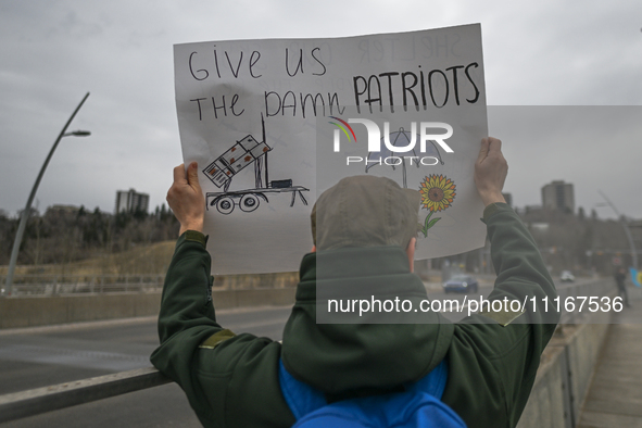 EDMONTON, CANADA - APRIL 21, 2024:
Members of the Ukrainian diaspora proudly wave national flags, hold blue and yellow balloons, and display...