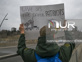 EDMONTON, CANADA - APRIL 21, 2024:
Members of the Ukrainian diaspora proudly wave national flags, hold blue and yellow balloons, and display...