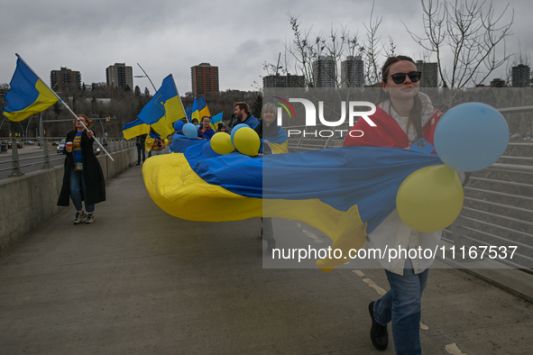 EDMONTON, CANADA - APRIL 21, 2024:
Members of the Ukrainian diaspora proudly wave national flags, hold blue and yellow balloons, and display...