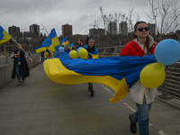 EDMONTON, CANADA - APRIL 21, 2024:
Members of the Ukrainian diaspora proudly wave national flags, hold blue and yellow balloons, and display...