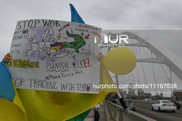 EDMONTON, CANADA - APRIL 21, 2024:
Members of the Ukrainian diaspora proudly wave national flags, hold blue and yellow balloons, and display...