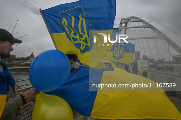 EDMONTON, CANADA - APRIL 21, 2024:
Members of the Ukrainian diaspora proudly wave national flags, hold blue and yellow balloons, and display...