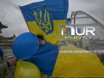 EDMONTON, CANADA - APRIL 21, 2024:
Members of the Ukrainian diaspora proudly wave national flags, hold blue and yellow balloons, and display...