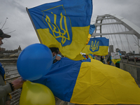 EDMONTON, CANADA - APRIL 21, 2024:
Members of the Ukrainian diaspora proudly wave national flags, hold blue and yellow balloons, and display...