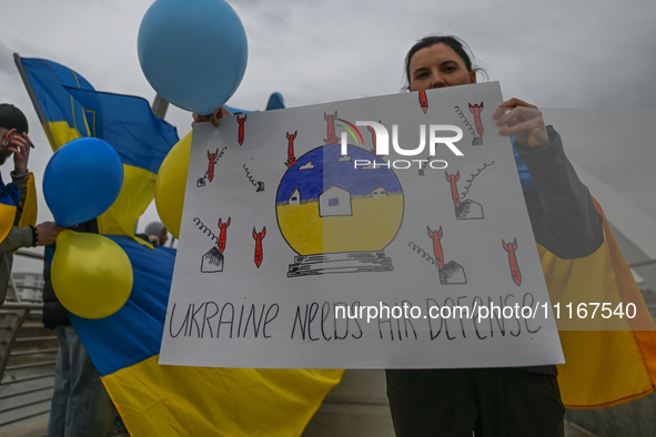 EDMONTON, CANADA - APRIL 21, 2024:
Members of the Ukrainian diaspora proudly wave national flags, hold blue and yellow balloons, and display...