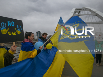 EDMONTON, CANADA - APRIL 21, 2024:
Members of the Ukrainian diaspora proudly wave national flags, hold blue and yellow balloons, and display...