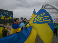 EDMONTON, CANADA - APRIL 21, 2024:
Members of the Ukrainian diaspora proudly wave national flags, hold blue and yellow balloons, and display...