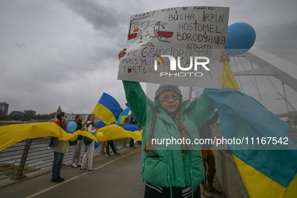 EDMONTON, CANADA - APRIL 21, 2024:
Members of the Ukrainian diaspora proudly wave national flags, hold blue and yellow balloons, and display...