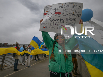 EDMONTON, CANADA - APRIL 21, 2024:
Members of the Ukrainian diaspora proudly wave national flags, hold blue and yellow balloons, and display...