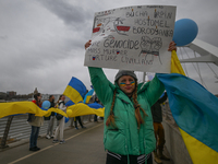 EDMONTON, CANADA - APRIL 21, 2024:
Members of the Ukrainian diaspora proudly wave national flags, hold blue and yellow balloons, and display...