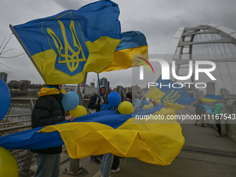 EDMONTON, CANADA - APRIL 21, 2024:
Members of the Ukrainian diaspora proudly wave national flags, hold blue and yellow balloons, and display...