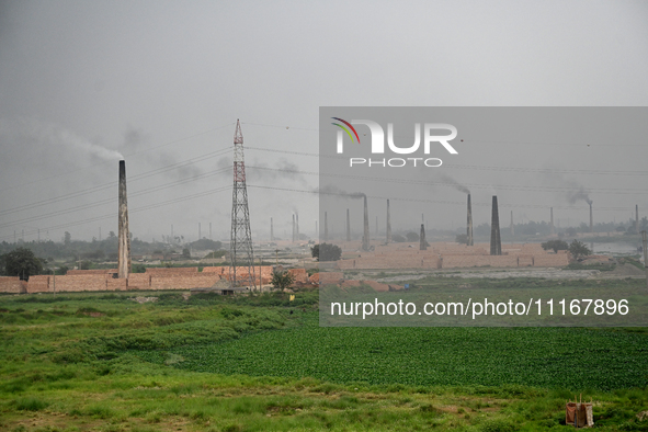 Smoke is emitting from the chimneys at a brick factory on the outskirts of Dhaka, Bangladesh, on April 22, 2024. These brick factories are c...