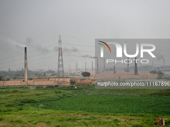 Smoke is emitting from the chimneys at a brick factory on the outskirts of Dhaka, Bangladesh, on April 22, 2024. These brick factories are c...