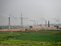 Smoke is emitting from the chimneys at a brick factory on the outskirts of Dhaka, Bangladesh, on April 22, 2024. These brick factories are c...