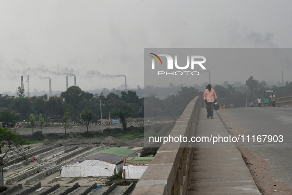 Smoke is emitting from the chimneys at a brick factory on the outskirts of Dhaka, Bangladesh, on April 22, 2024. These brick factories are c...