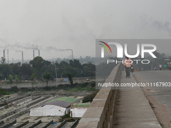 Smoke is emitting from the chimneys at a brick factory on the outskirts of Dhaka, Bangladesh, on April 22, 2024. These brick factories are c...