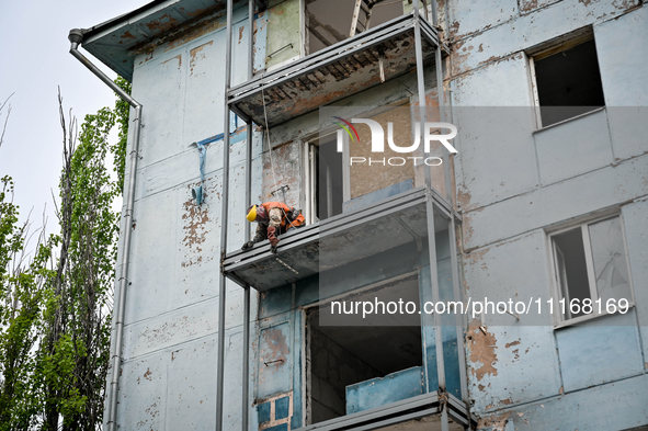 Workers are reconstructing a residential building damaged by a Russian missile strike on the night of March 2, 2023, at 67 Nezalezhnoyi Ukra...