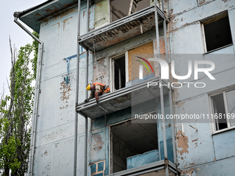 Workers are reconstructing a residential building damaged by a Russian missile strike on the night of March 2, 2023, at 67 Nezalezhnoyi Ukra...