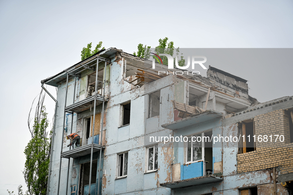 Workers are reconstructing a residential building damaged by a Russian missile strike on the night of March 2, 2023, at 67 Nezalezhnoyi Ukra...