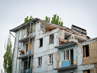 Workers are reconstructing a residential building damaged by a Russian missile strike on the night of March 2, 2023, at 67 Nezalezhnoyi Ukra...