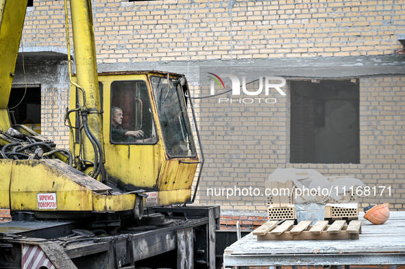 Workers are reconstructing a residential building damaged by a Russian missile strike on the night of March 2, 2023, at 67 Nezalezhnoyi Ukra...