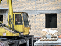 Workers are reconstructing a residential building damaged by a Russian missile strike on the night of March 2, 2023, at 67 Nezalezhnoyi Ukra...