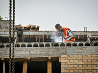 Workers are reconstructing a residential building damaged by a Russian missile strike on the night of March 2, 2023, at 67 Nezalezhnoyi Ukra...