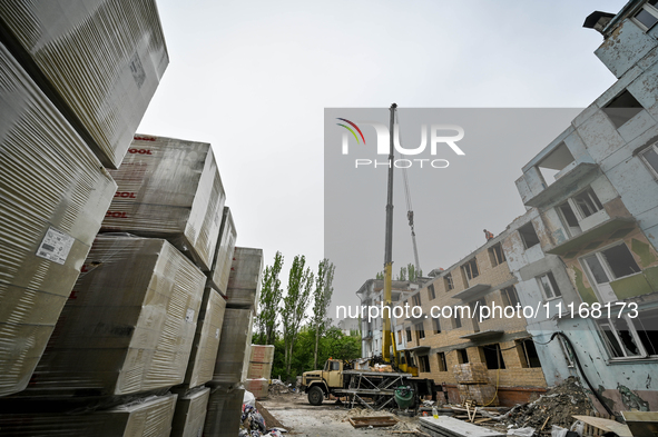 Workers are reconstructing a residential building damaged by a Russian missile strike on the night of March 2, 2023, at 67 Nezalezhnoyi Ukra...