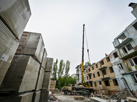 Workers are reconstructing a residential building damaged by a Russian missile strike on the night of March 2, 2023, at 67 Nezalezhnoyi Ukra...