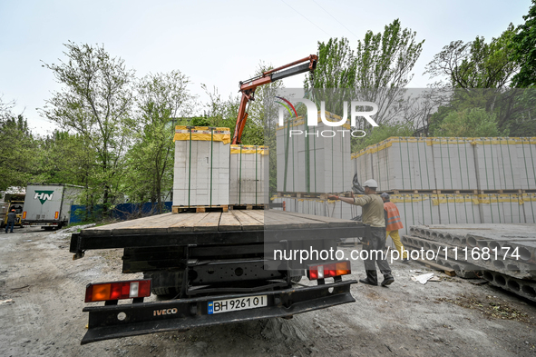 Workers are reconstructing a residential building damaged by a Russian missile strike on the night of March 2, 2023, at 67 Nezalezhnoyi Ukra...