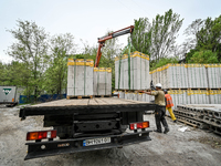 Workers are reconstructing a residential building damaged by a Russian missile strike on the night of March 2, 2023, at 67 Nezalezhnoyi Ukra...