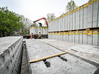 Workers are reconstructing a residential building damaged by a Russian missile strike on the night of March 2, 2023, at 67 Nezalezhnoyi Ukra...