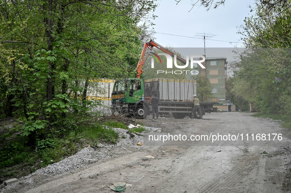 Workers are reconstructing a residential building damaged by a Russian missile strike on the night of March 2, 2023, at 67 Nezalezhnoyi Ukra...