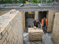 Workers are reconstructing a residential building damaged by a Russian missile strike on the night of March 2, 2023, at 67 Nezalezhnoyi Ukra...