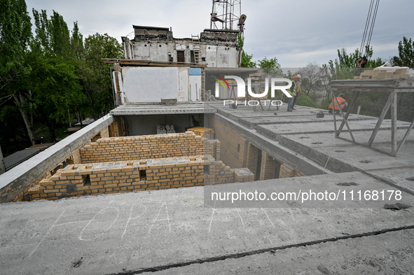 Workers are reconstructing a residential building damaged by a Russian missile strike on the night of March 2, 2023, at 67 Nezalezhnoyi Ukra...