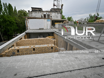 Workers are reconstructing a residential building damaged by a Russian missile strike on the night of March 2, 2023, at 67 Nezalezhnoyi Ukra...