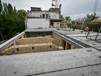 Workers are reconstructing a residential building damaged by a Russian missile strike on the night of March 2, 2023, at 67 Nezalezhnoyi Ukra...