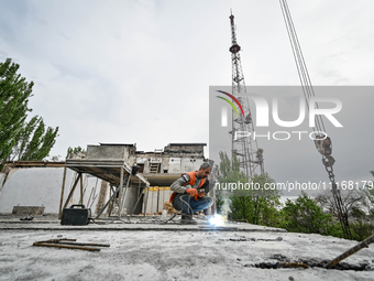 Workers are reconstructing a residential building damaged by a Russian missile strike on the night of March 2, 2023, at 67 Nezalezhnoyi Ukra...