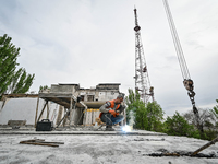 Workers are reconstructing a residential building damaged by a Russian missile strike on the night of March 2, 2023, at 67 Nezalezhnoyi Ukra...