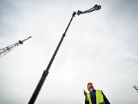 Workers are reconstructing a residential building damaged by a Russian missile strike on the night of March 2, 2023, at 67 Nezalezhnoyi Ukra...