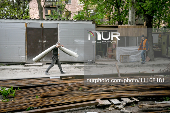 Workers are reconstructing a residential building damaged by a Russian missile strike on the night of March 2, 2023, at 67 Nezalezhnoyi Ukra...