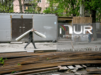 Workers are reconstructing a residential building damaged by a Russian missile strike on the night of March 2, 2023, at 67 Nezalezhnoyi Ukra...