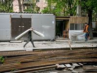 Workers are reconstructing a residential building damaged by a Russian missile strike on the night of March 2, 2023, at 67 Nezalezhnoyi Ukra...