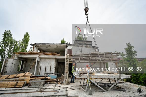 Workers are reconstructing a residential building damaged by a Russian missile strike on the night of March 2, 2023, at 67 Nezalezhnoyi Ukra...