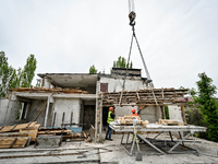 Workers are reconstructing a residential building damaged by a Russian missile strike on the night of March 2, 2023, at 67 Nezalezhnoyi Ukra...