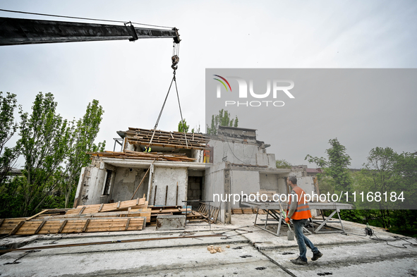 Workers are reconstructing a residential building damaged by a Russian missile strike on the night of March 2, 2023, at 67 Nezalezhnoyi Ukra...