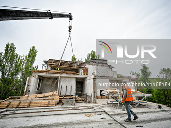 Workers are reconstructing a residential building damaged by a Russian missile strike on the night of March 2, 2023, at 67 Nezalezhnoyi Ukra...